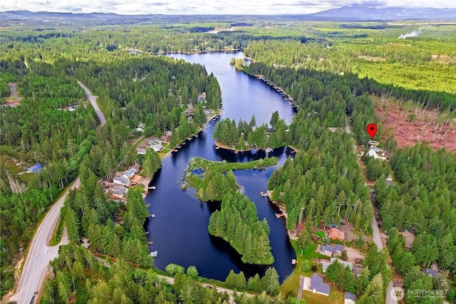 aerial view with a forest view and a water view