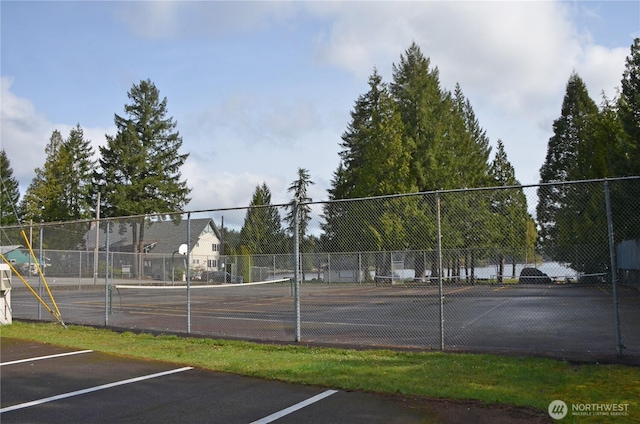 view of sport court featuring fence