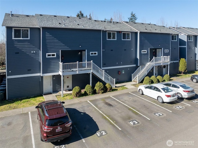 exterior space with uncovered parking and stairway