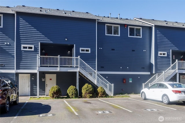 exterior space featuring uncovered parking and stairs