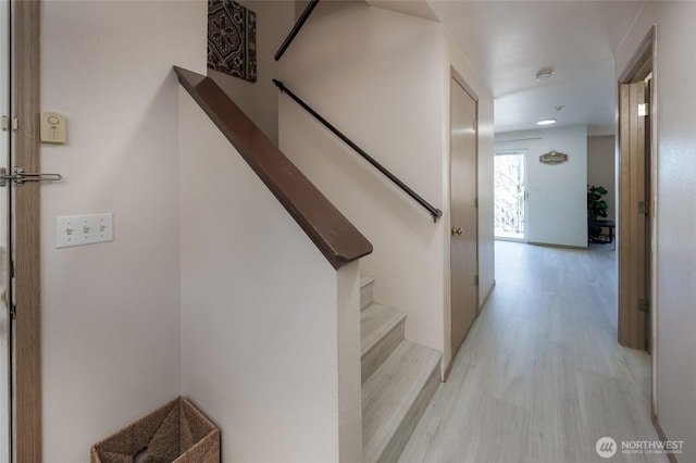 stairway with wood finished floors