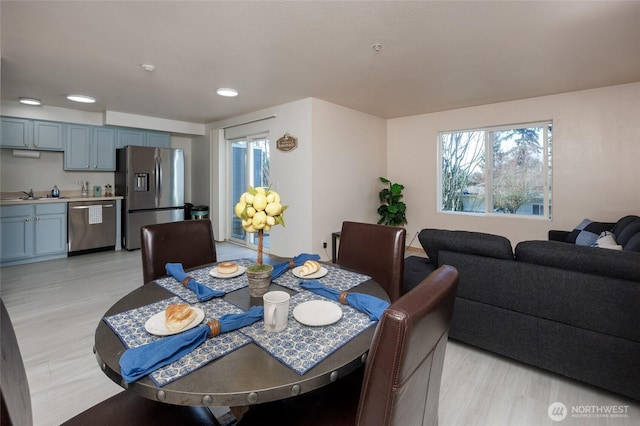 dining area featuring light wood finished floors and recessed lighting