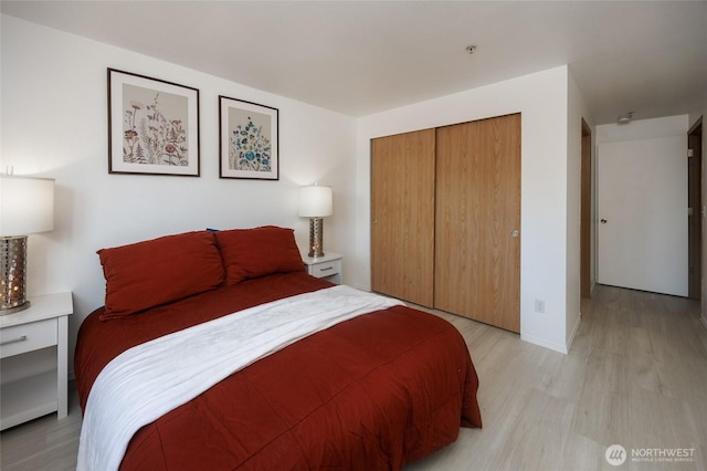 bedroom featuring a closet and light wood-type flooring