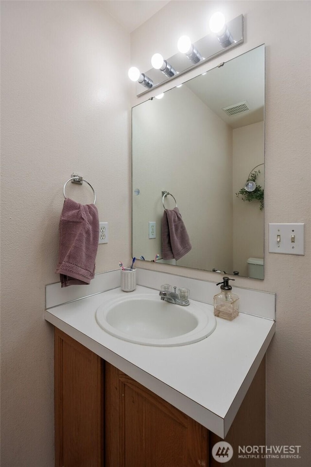 bathroom featuring visible vents and vanity