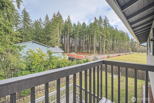 balcony featuring a forest view