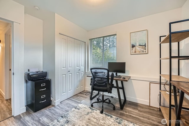 home office featuring baseboards and wood finished floors