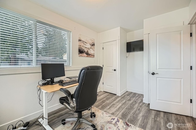 office featuring baseboards and wood finished floors