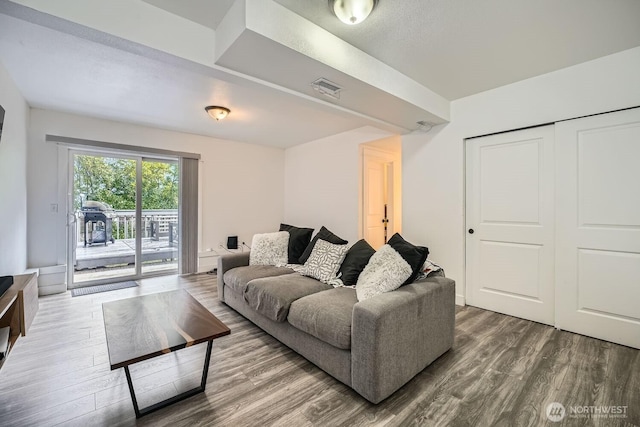 living room with wood finished floors and visible vents