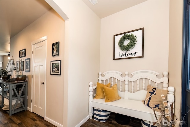 interior space featuring arched walkways, dark wood finished floors, and baseboards