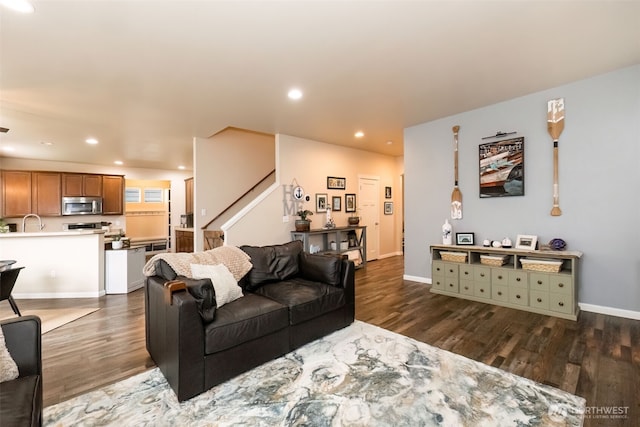 living room with baseboards, dark wood finished floors, and recessed lighting