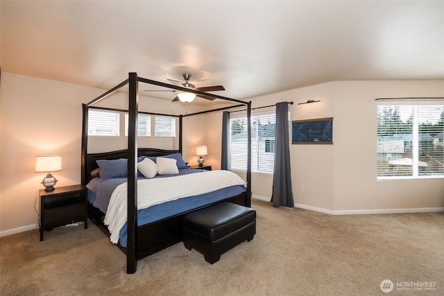 bedroom featuring multiple windows, baseboards, and light colored carpet