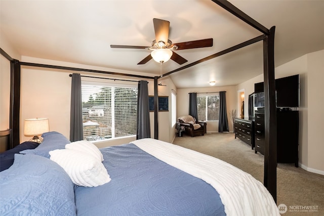 carpeted bedroom featuring ceiling fan, vaulted ceiling, and baseboards