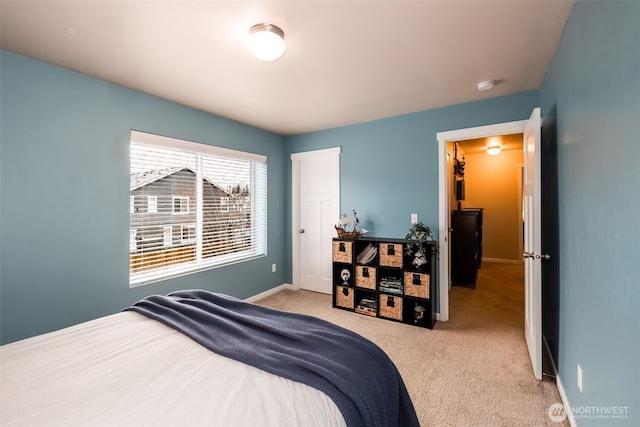 carpeted bedroom with baseboards