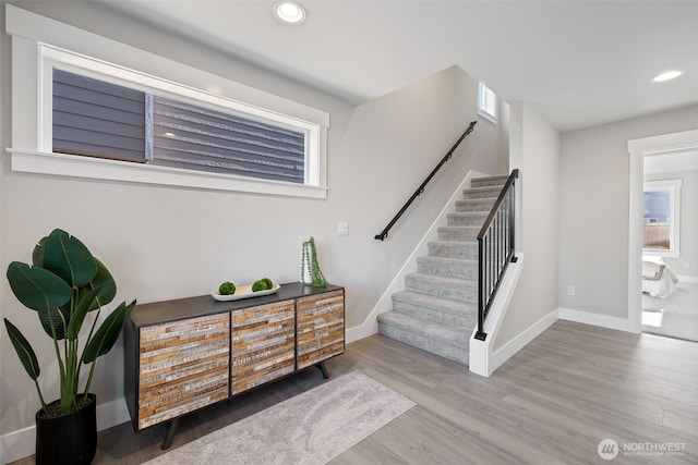 foyer featuring stairway, baseboards, wood finished floors, and recessed lighting