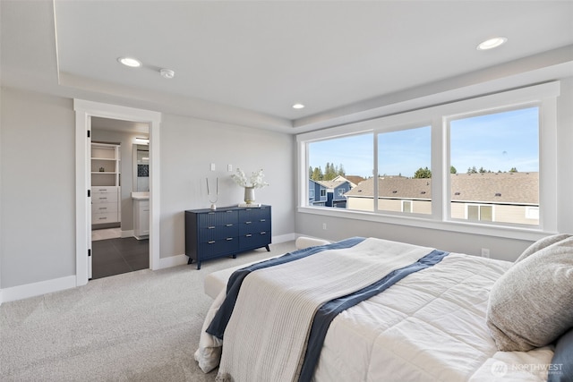 bedroom with recessed lighting, light carpet, baseboards, and multiple windows