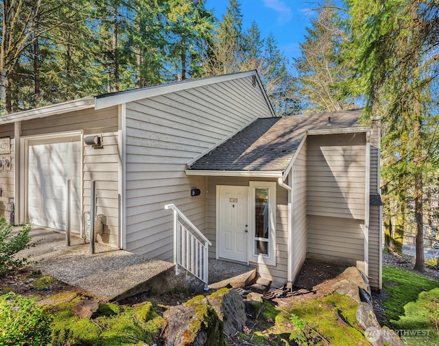 exterior space featuring roof with shingles