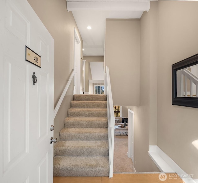 stairway featuring baseboards and recessed lighting