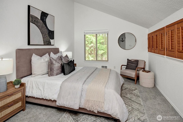 carpeted bedroom featuring baseboards, visible vents, vaulted ceiling, and a textured ceiling