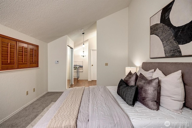 bedroom with lofted ceiling, a textured ceiling, baseboards, and carpet flooring