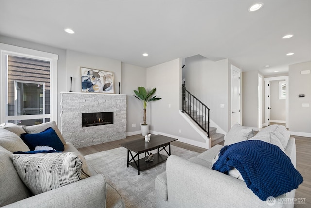 living area with stairway, wood finished floors, and recessed lighting