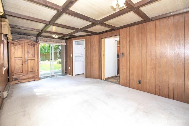 unfurnished room featuring beamed ceiling, wood walls, and coffered ceiling