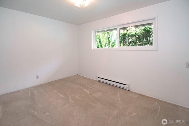 carpeted spare room with a baseboard radiator