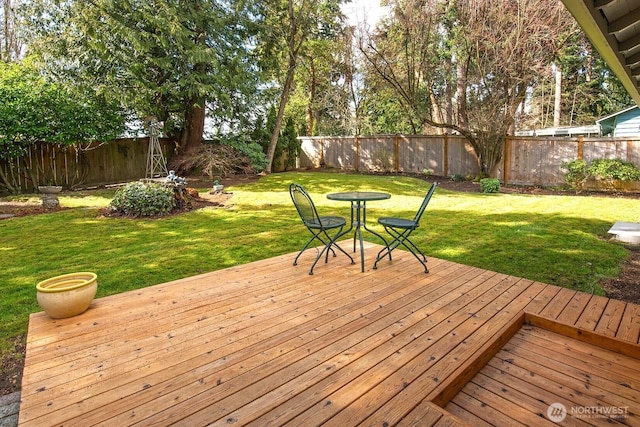 wooden deck with a fenced backyard and a yard