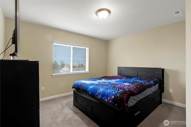 bedroom with light carpet, visible vents, and baseboards