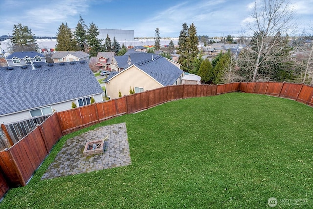 view of yard with a patio area, a fenced backyard, and a residential view