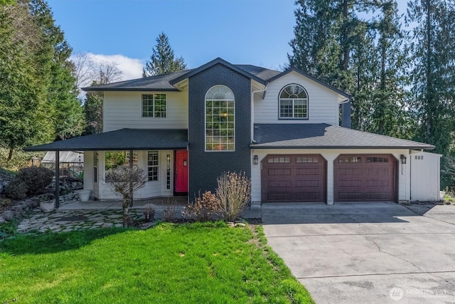 view of front of property featuring a front lawn, roof with shingles, concrete driveway, a garage, and brick siding