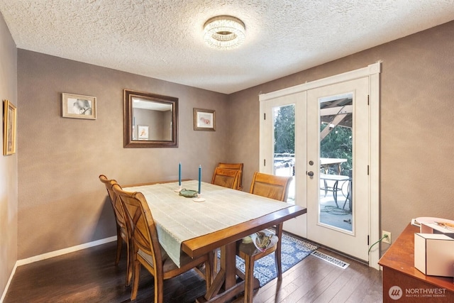 dining area with visible vents, baseboards, dark wood-style flooring, french doors, and a textured ceiling