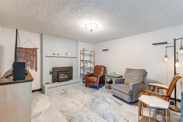 living area featuring a textured ceiling, marble finish floor, and a fireplace