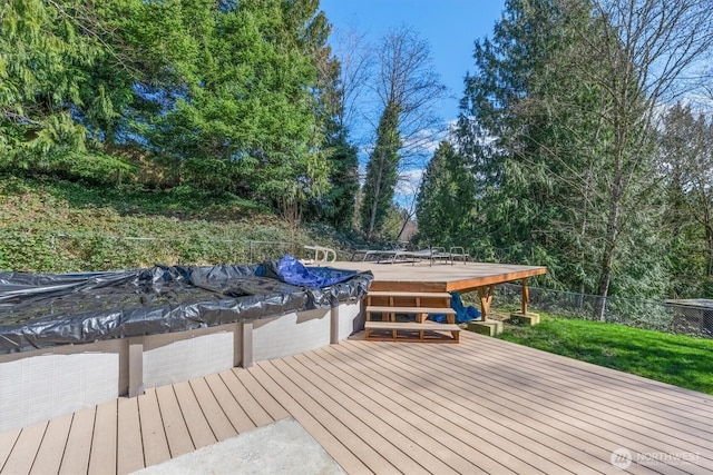 wooden deck with a covered pool and fence