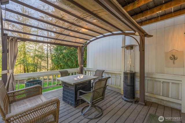 wooden deck with central air condition unit, outdoor dining space, and a pergola