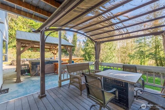 wooden deck with outdoor dining area and a hot tub