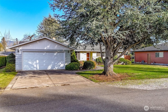 ranch-style house with a garage, a front lawn, and concrete driveway