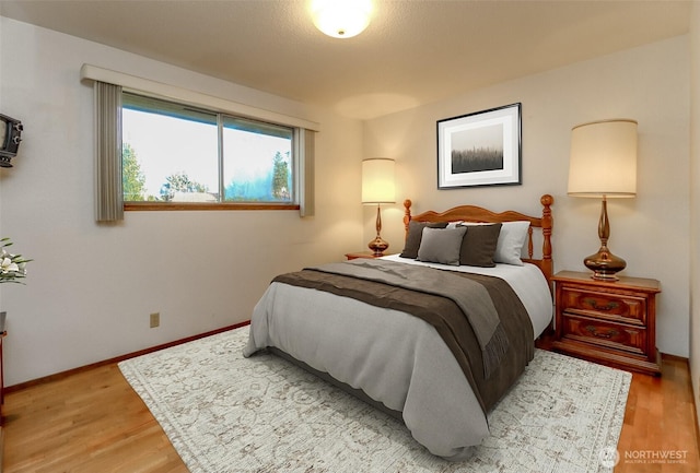 bedroom featuring light wood-type flooring and baseboards