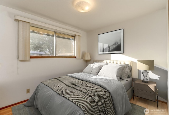 bedroom featuring baseboards and wood finished floors