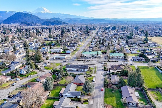 birds eye view of property with a mountain view and a residential view