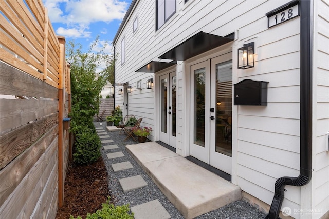 doorway to property featuring french doors and fence