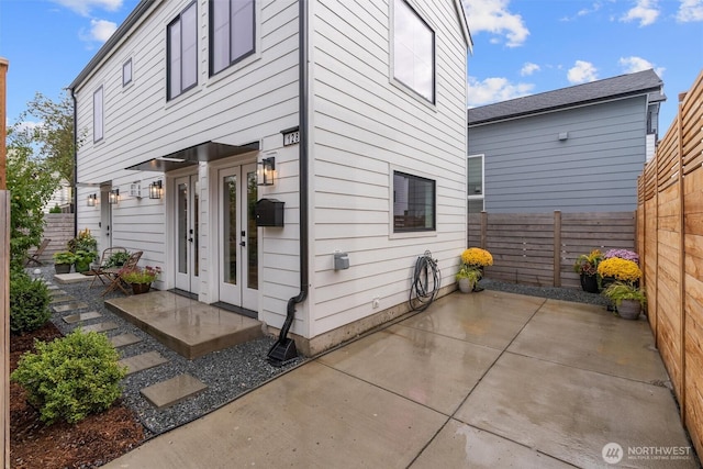 back of house with a patio, french doors, and a fenced backyard