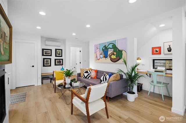 living room featuring recessed lighting, a wall unit AC, and light wood-style floors