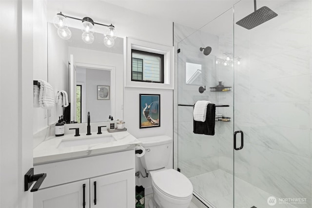 full bathroom with toilet, a shower stall, and vanity