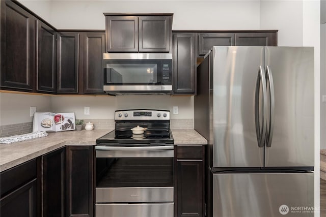 kitchen featuring light countertops, appliances with stainless steel finishes, and dark brown cabinetry