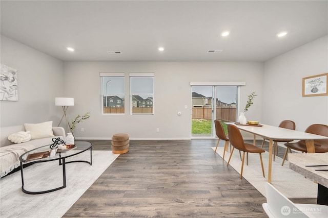 living room featuring recessed lighting, visible vents, and wood finished floors