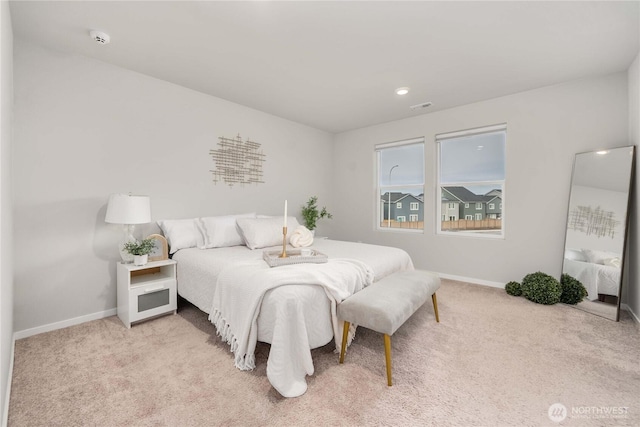 bedroom featuring visible vents, baseboards, and light colored carpet