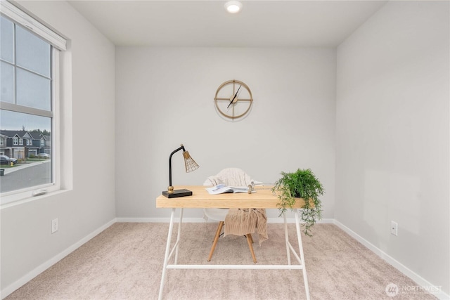 office space featuring a healthy amount of sunlight, baseboards, and carpet floors