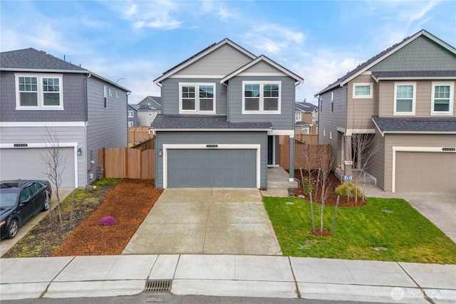 craftsman-style house with driveway, a front lawn, an attached garage, and fence