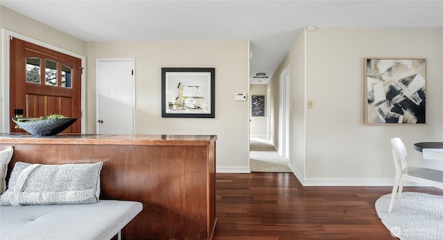 interior space featuring baseboards and dark wood-type flooring