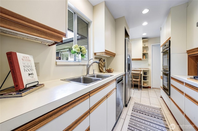 kitchen with light countertops, recessed lighting, appliances with stainless steel finishes, and a sink